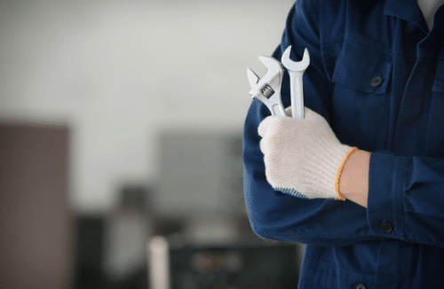 Mechanic holding tools for exotic car repair